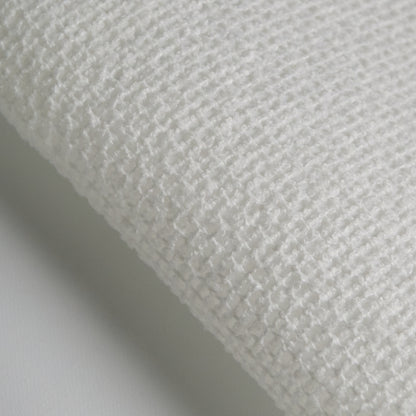 Close-up of BOUCLE fabric showing textured white polyester weave for upholstery and design.