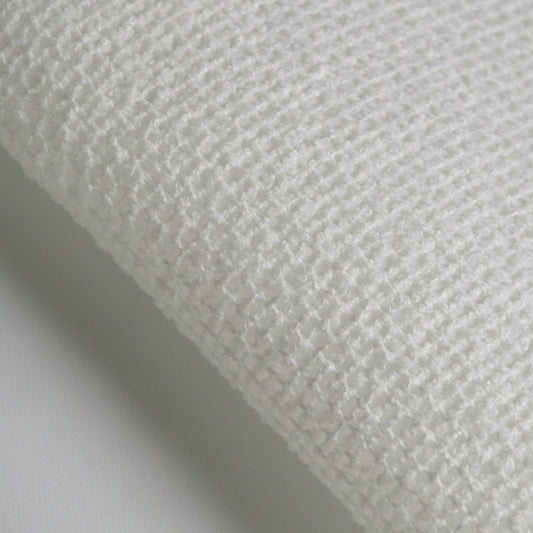 Close-up of BOUCLE fabric showing textured white polyester weave for upholstery and design.
