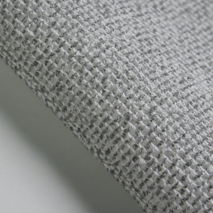 Close-up of BOUCLE fabric texture in grey, highlighting the woven pattern and soft feel.