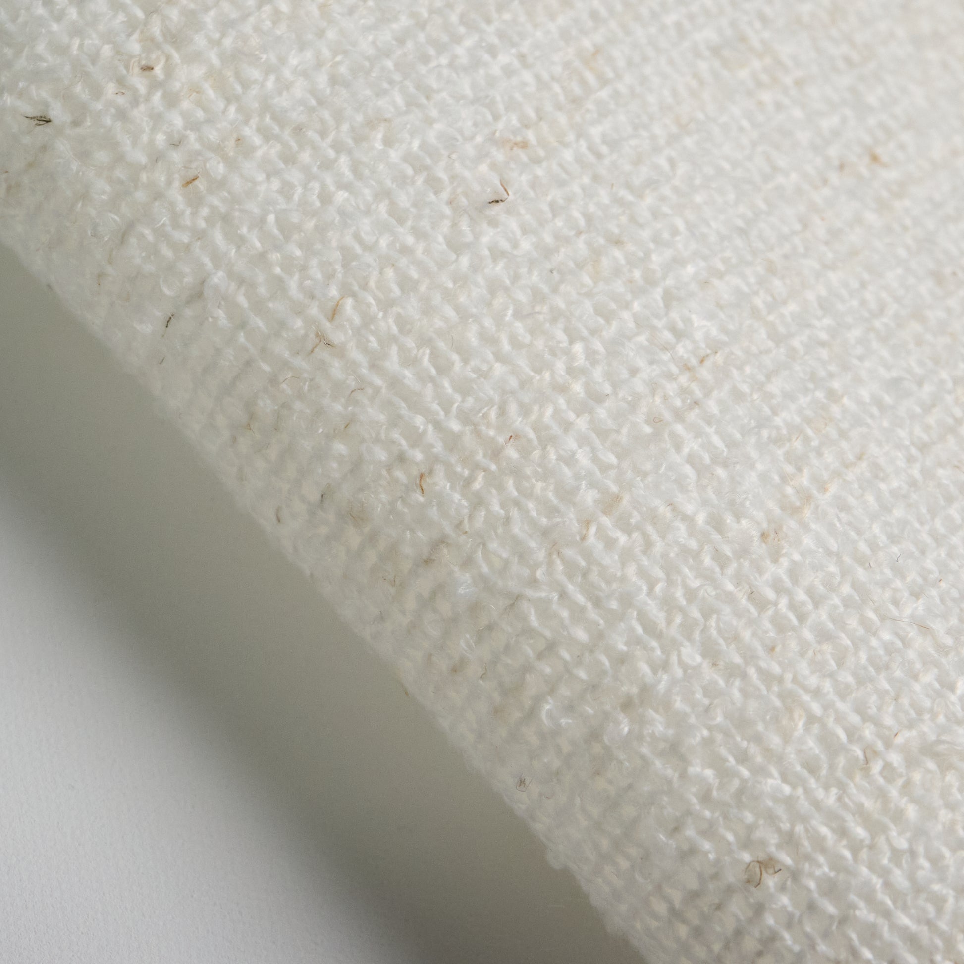 Close-up of BOUCLE fabric in off-white color, showing texture and composition for textile applications.